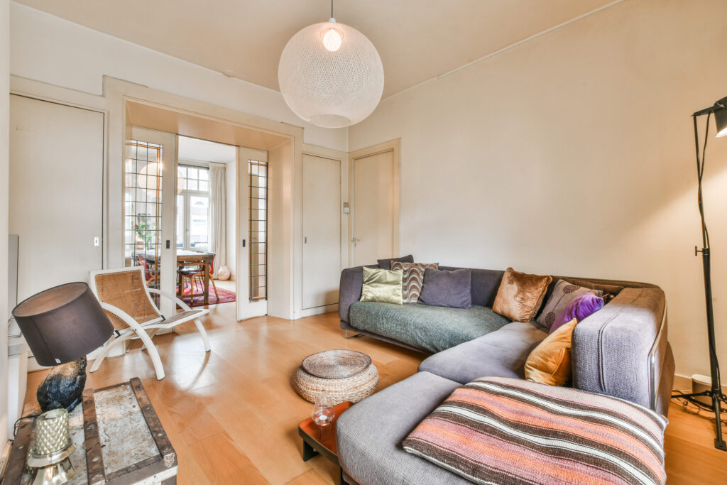 a living room with a gray couch and a chair